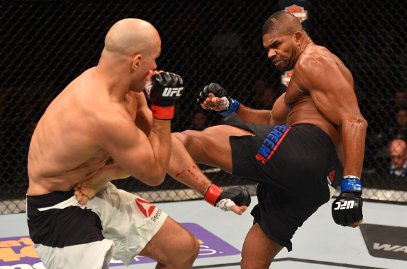 ORLANDO, FL - DECEMBER 19:   (R-L) Alistair Overeem kicks Junior dos Santos in their heavyweight bout during the UFC Fight Night event at the Amway Center on December 19, 2015 in Orlando, Florida. (Photo by Josh Hedges/Zuffa LLC/Zuffa LLC via Getty Images)